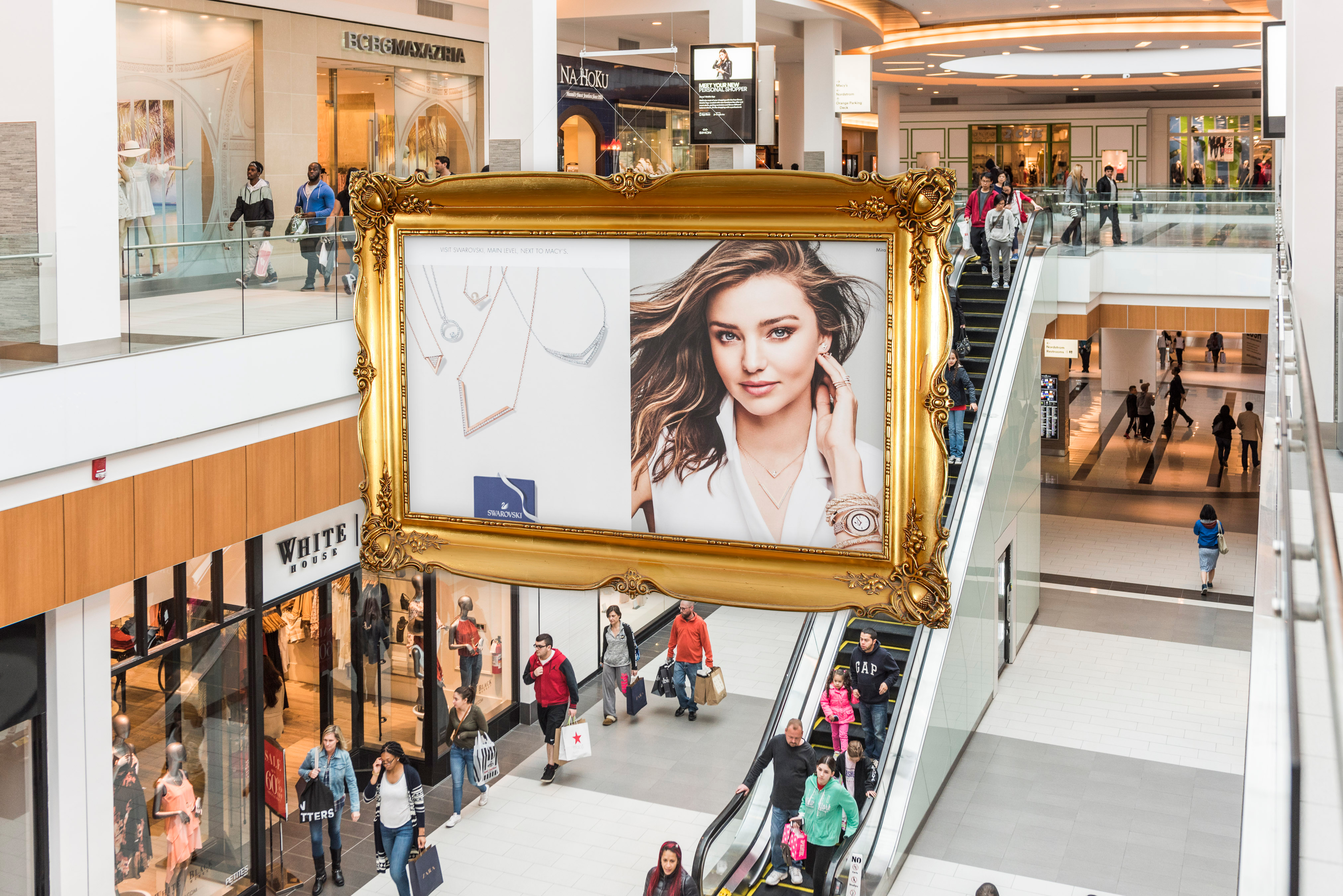 Ceiling hoist holding a banner inside of a mall