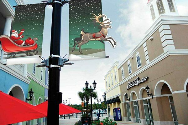 Holiday themed light pole banners with santa and his sleigh