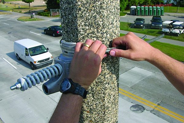 Banner saver installation putting the bands on the light pole.