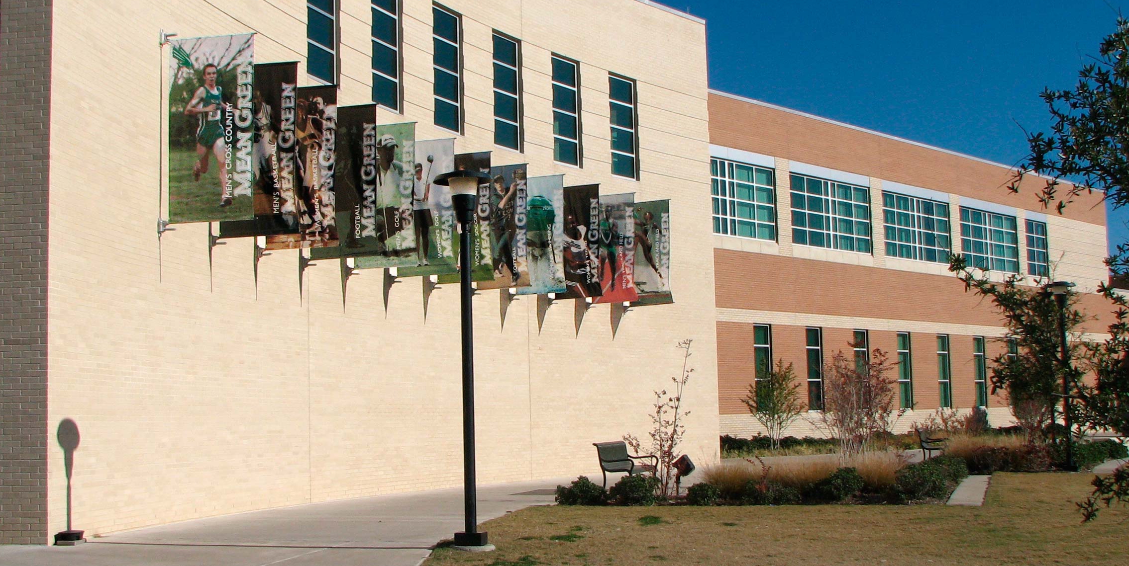 BannerSaver™ brackets mounted on a university building exterior wall
